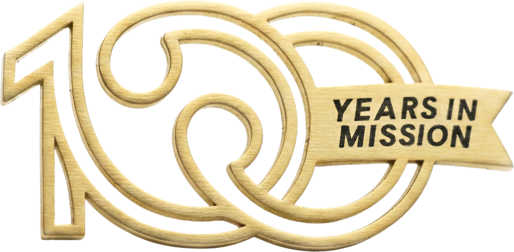 The 100 Years in Mission mark in brushed gold