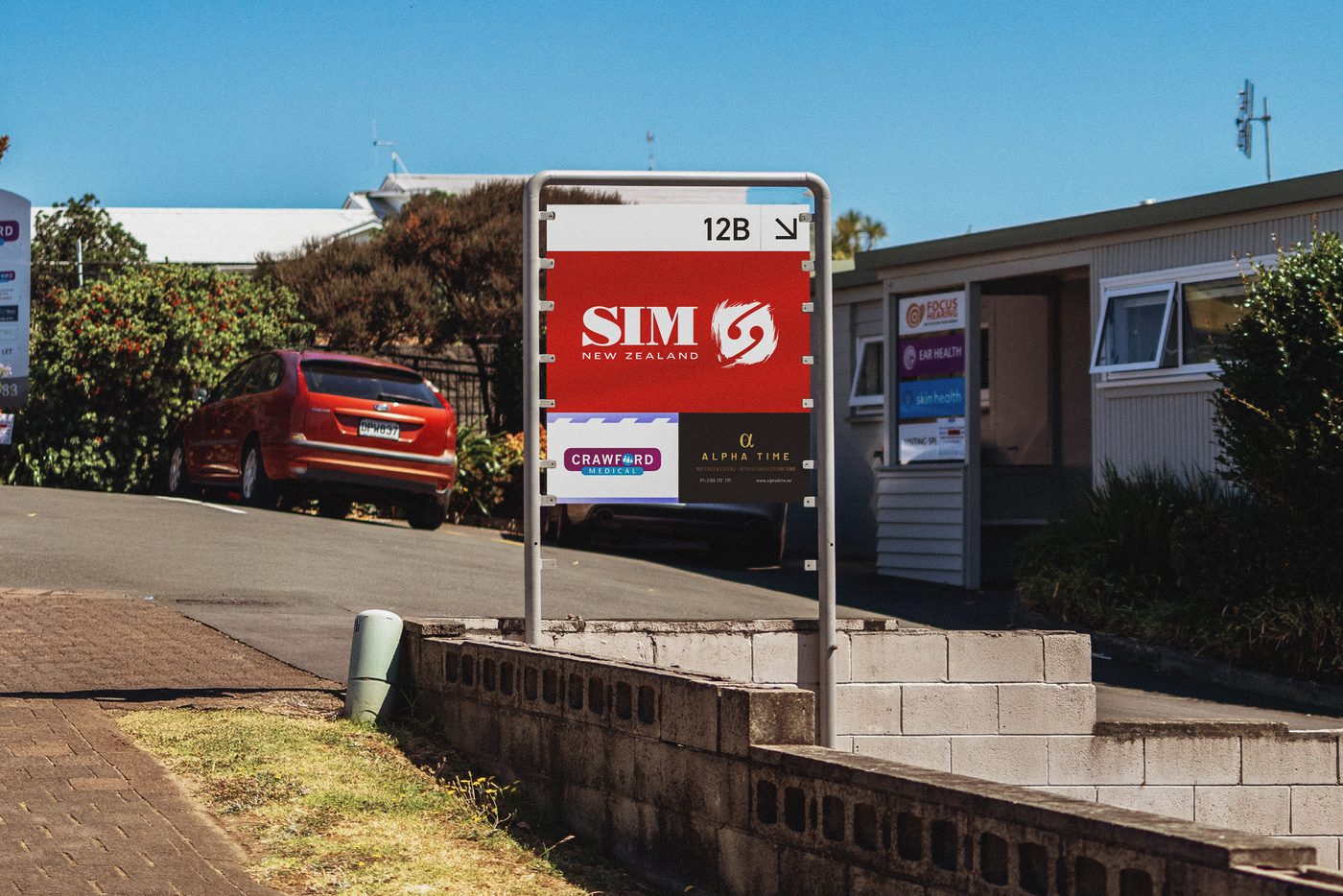 SIM New Zealand logo on a red street sign