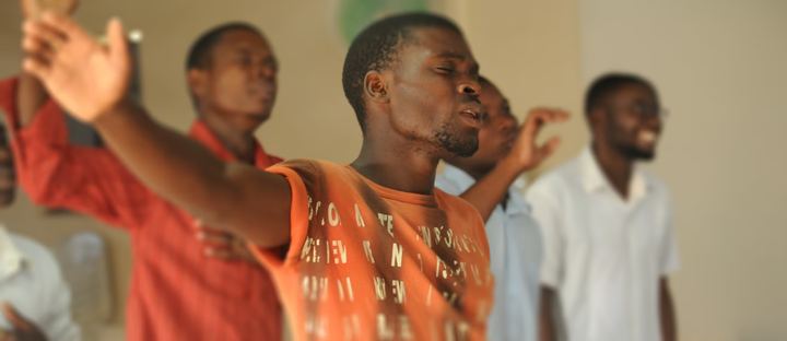 Young men singing and worshipping together