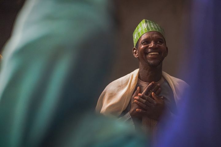 A joyful man worshipping with his hands together